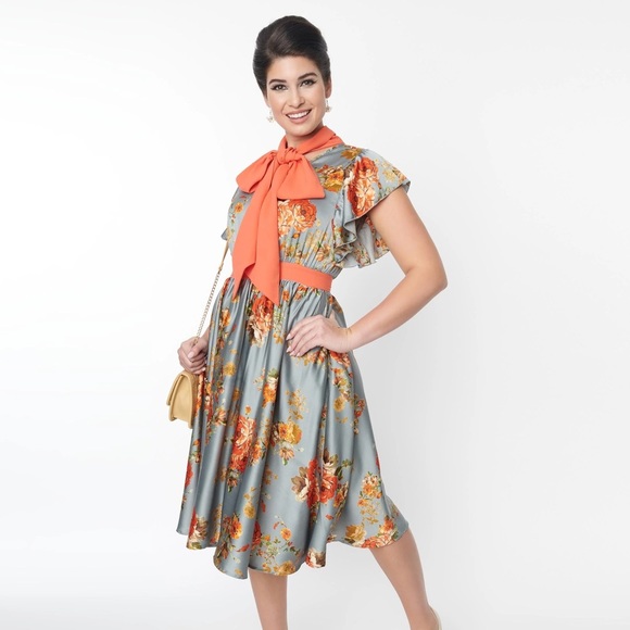 This swing dress is crafted in a blue satin fabric, adorned with orange florals. - Picture 1 of 4
